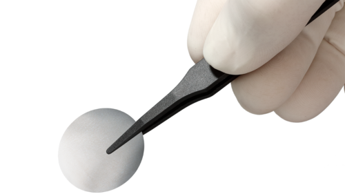 A aluminum-coated membrane held by a hand with a pair of tweezers