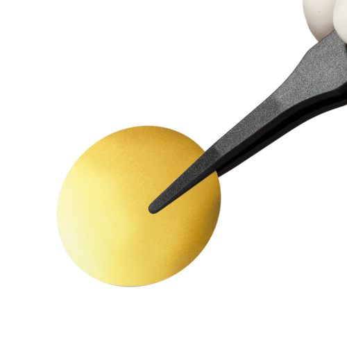 A gold-coated membrane held by a pair of tweezers
